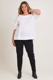 Model Chanel wearing size 16 of the Bliss Top in colour White (White), from the front, showing the whole outfit