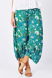 Model Anna wearing size 10 of the Printed Guru Pants in colour BlockGreen (Green), from the front, cropped image