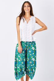 Model Anna wearing size 10 of the Printed Guru Pants in colour BlockGreen (Green), from the front, cropped image