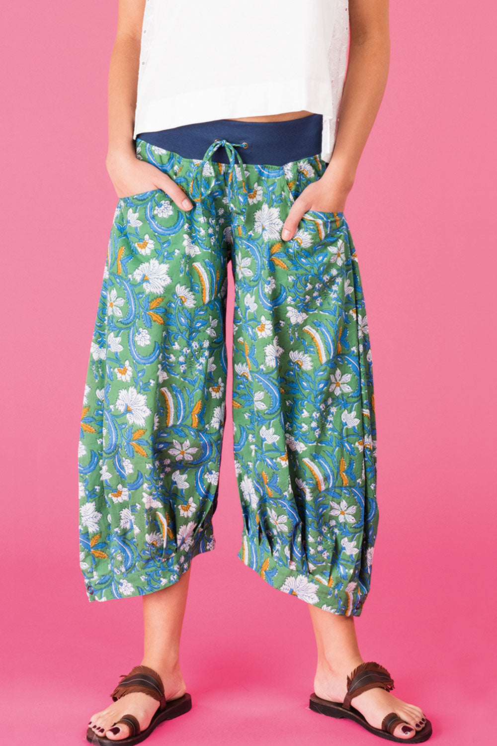A model wearing the Printed Guru Pants in colour BlockGreen (Green), from the front, cropped image