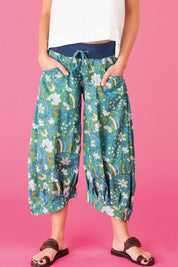 A model wearing the Printed Guru Pants in colour BlockGreen (Green), from the front, cropped image