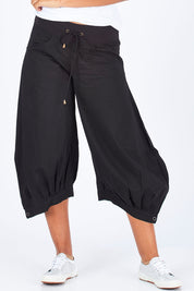 Model Summer wearing size 10 of the Guru Pant in colour Black (Black), from the front, cropped image