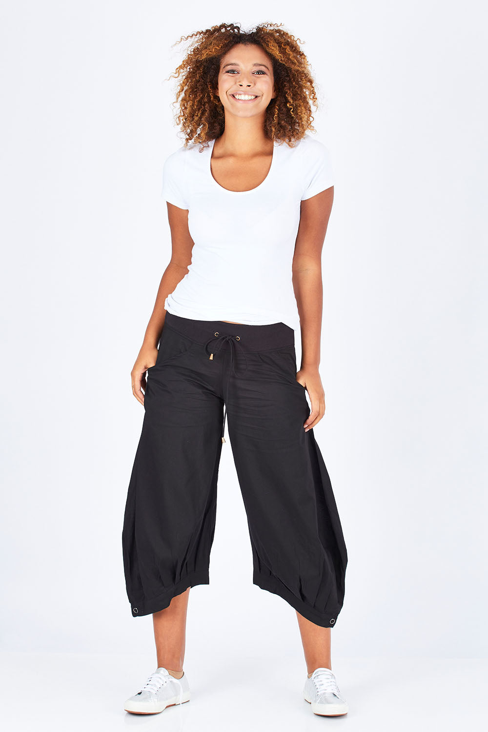 Model Summer wearing size 10 of the Guru Pant in colour Black (Black), from the front, showing the whole outfit