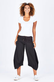 Model Summer wearing size 10 of the Guru Pant in colour Black (Black), from the front, showing the whole outfit