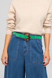 A model wearing the Flower Suede Belt in colour Peacock (Blue), from the front, showing the whole outfit