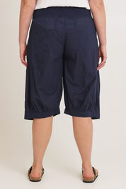 Model Chanel wearing size 16 of the Jada Short in colour Navy (Blue), from the back