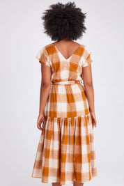 Model Olivia wearing size 10 of the Indy Dress in colour Gingerchec, from the back