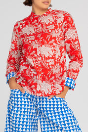 A model wearing the Cove Cotton Shirt in colour Farrah (Red), from the front, cropped image