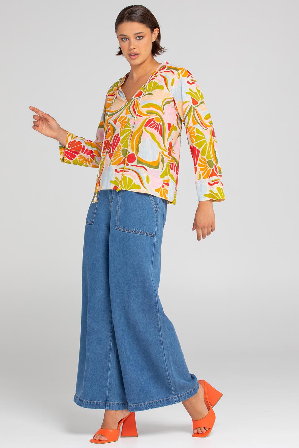 A model wearing the Hannah Cotton Top in colour Colada (Green), from the front, showing the whole outfit