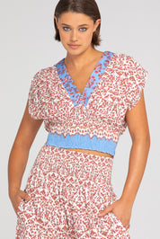 A model wearing the Desi Cotton Top in colour Paradise, from the front, cropped image