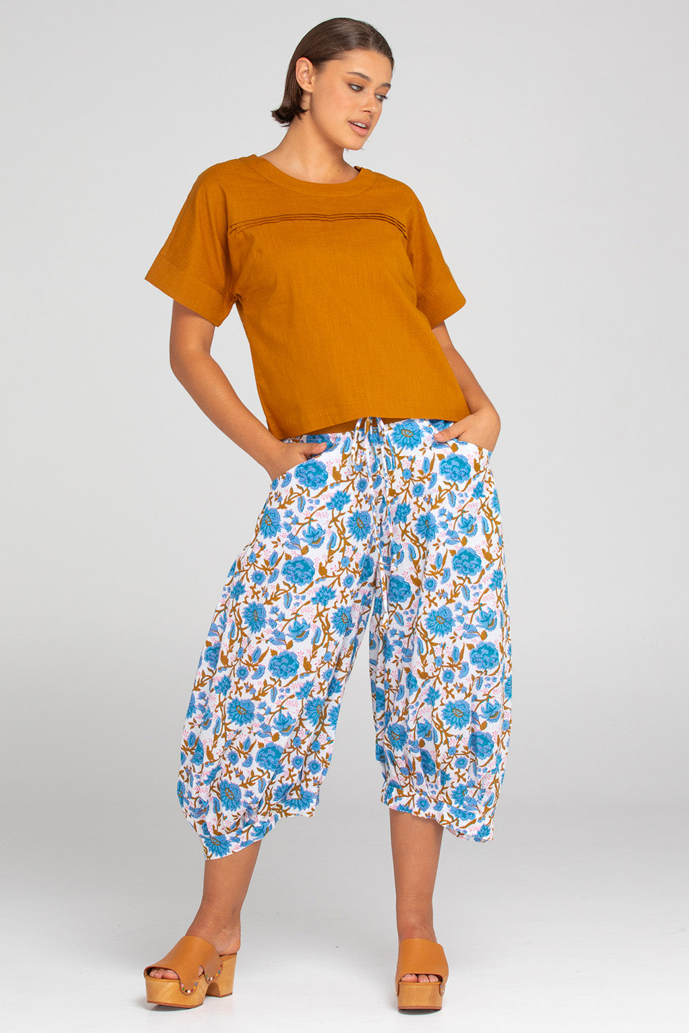 A model wearing the Haven Cotton Top in colour Mustard, from the front, showing the whole outfit