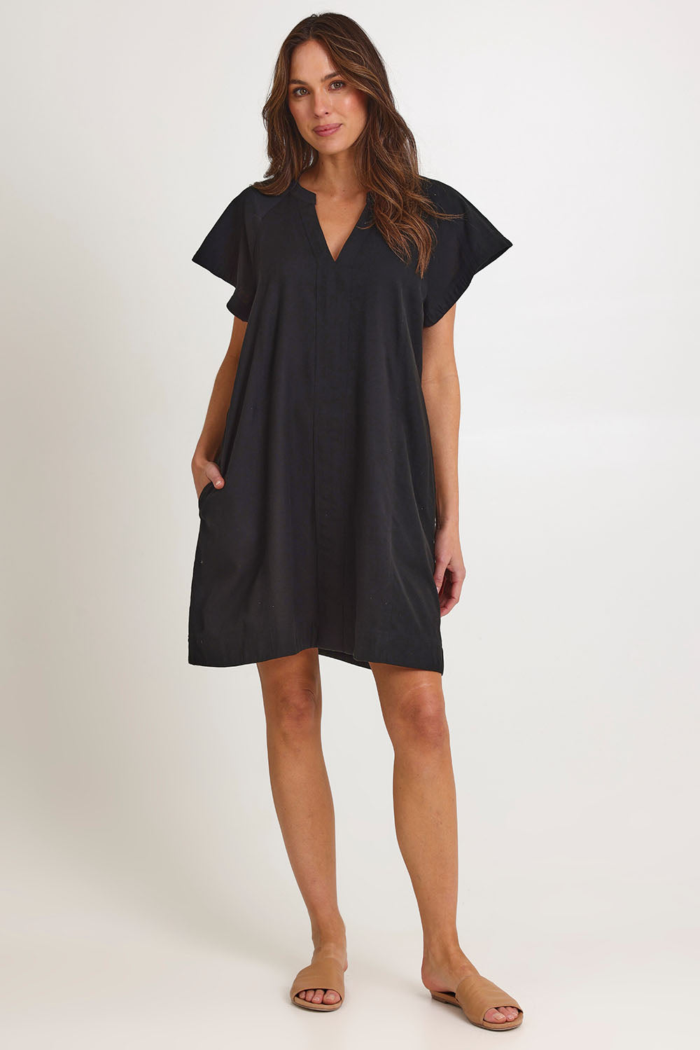 Model Madeline wearing size 10 of the Livy Cotton Dress in colour Black (Black), from the front, showing the whole outfit