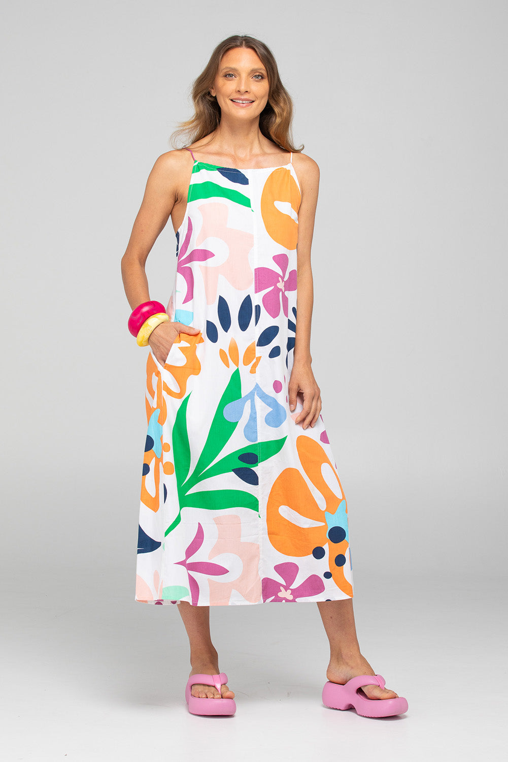 A model wearing the Aria Cotton Dress in colour Sorrento, from the front, showing the whole outfit