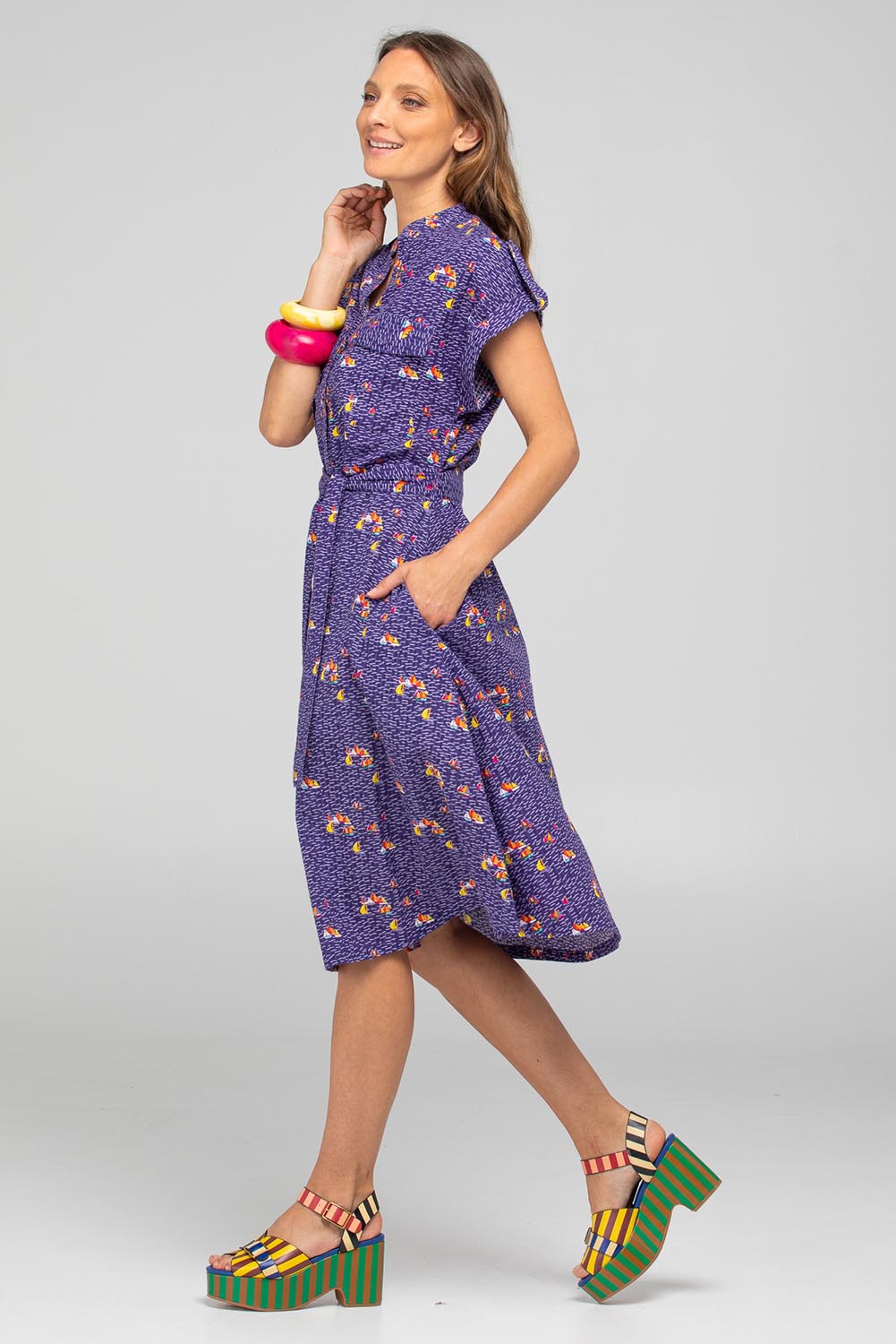A model wearing the Amalfi Cotton Dress in colour Amalfi (Blue), from the front, showing the whole outfit