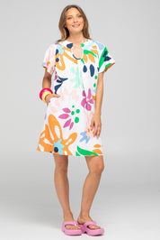 A model wearing the Etta Cotton Dress in colour Sorrento, from the front, showing the whole outfit