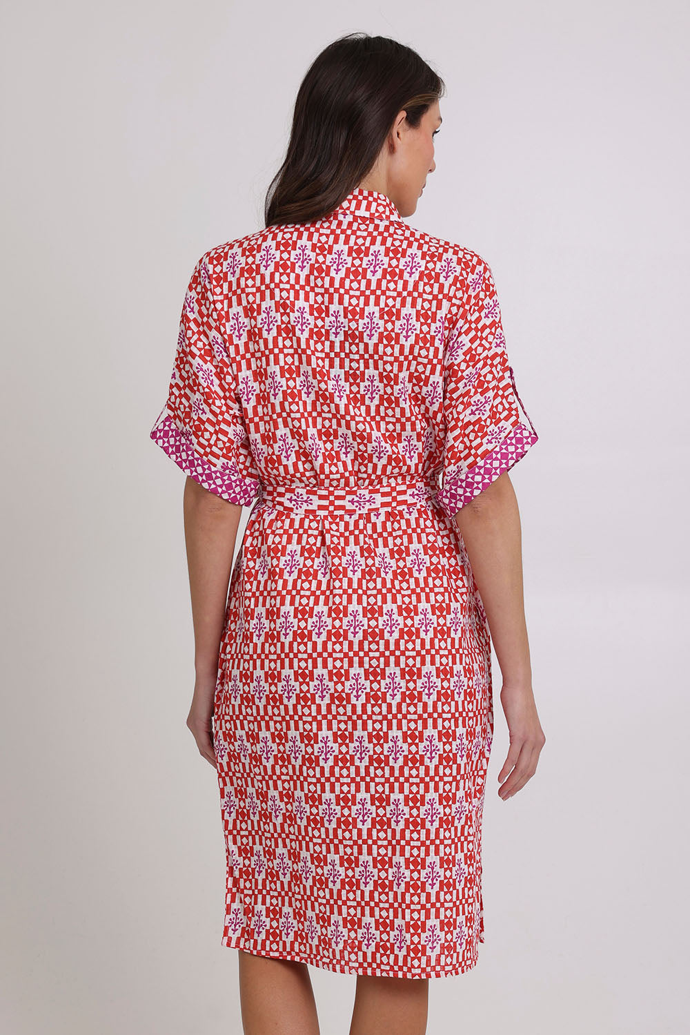 Model Madeline wearing size 10 of the Maui Cotton Shirt Dress in colour Naples (Pink), from the back