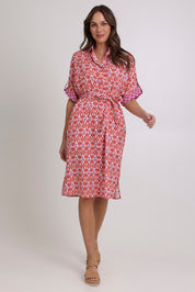 Model Madeline wearing size 10 of the Maui Cotton Shirt Dress in colour Naples (Pink), from the front, showing the whole outfit