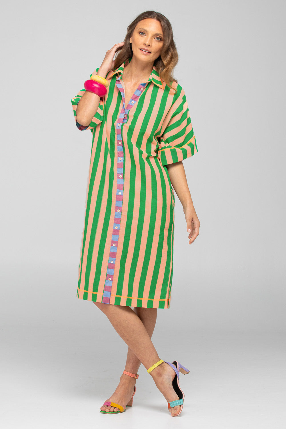 A model wearing the Maui Cotton Shirt Dress in colour Capri (Green), from the front, showing the whole outfit