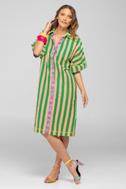 A model wearing the Maui Cotton Shirt Dress in colour Capri (Green), from the front, showing the whole outfit