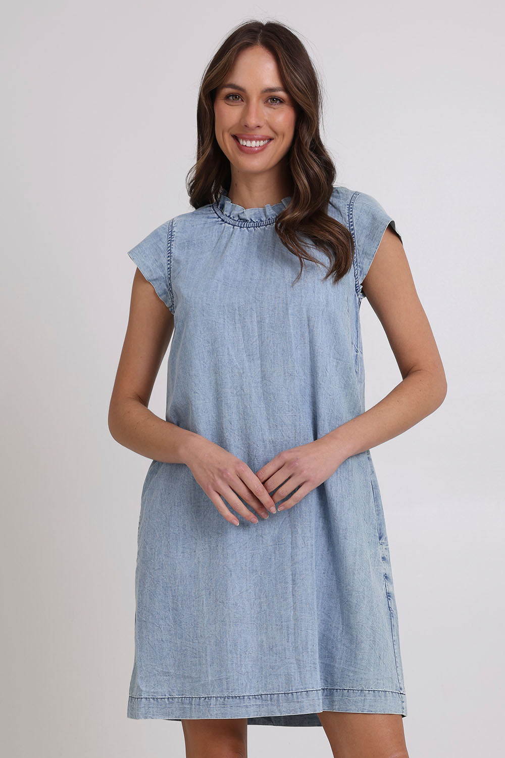 Model Madeline wearing size 10 of the Sand Lyocell Dress in colour Comoda (Blue), from the front, cropped image