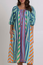 Model Madeline wearing size 10 of the Lucia Cotton Dress in colour Capris, from the front, cropped image