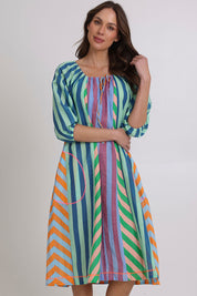 Model Madeline wearing size 10 of the Lucia Cotton Dress in colour Capris, from the front, cropped image