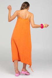 A model wearing the Arena Cotton Dress in colour Tangerine, from the back