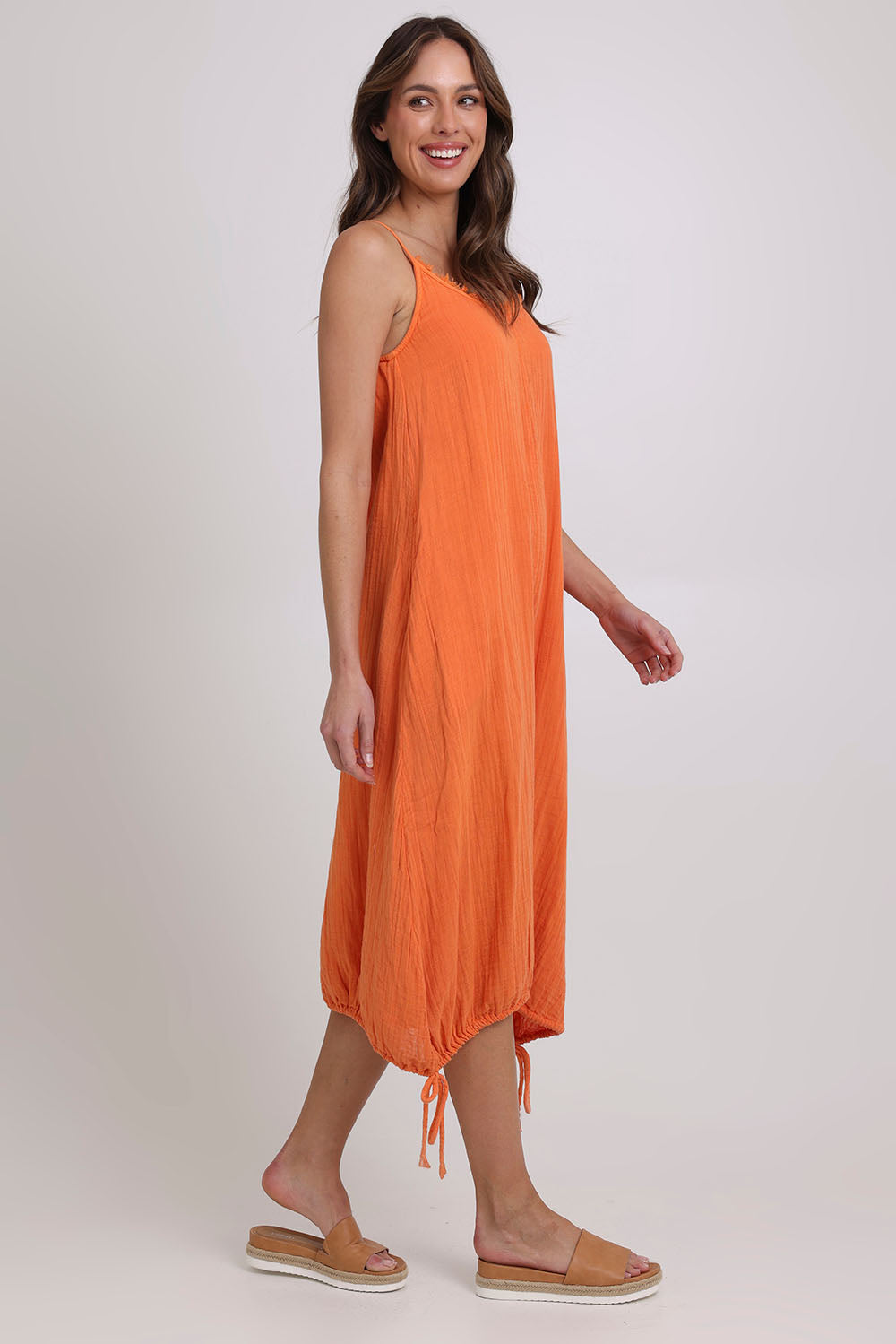 Model Madeline wearing size 10 of the Arena Cotton Dress in colour Tangerine, from the front, showing the whole outfit