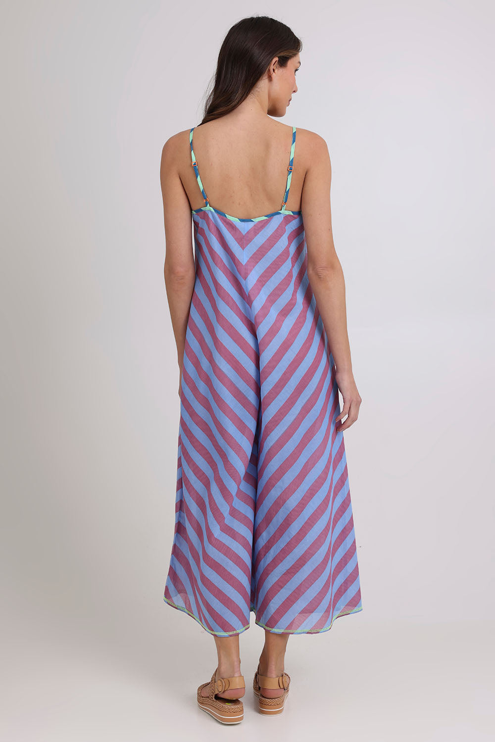 Model Madeline wearing size 10 of the Shimmi Cotton Jumpsuit in colour Capriblue (Blue), from the back