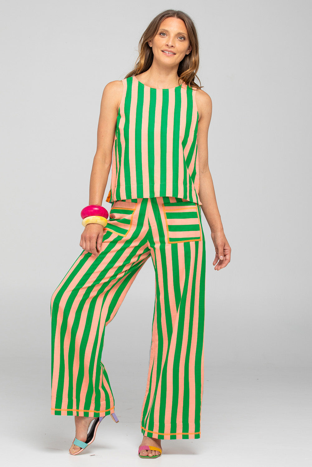 A model wearing the Sana Cotton Pant in colour Capri (Green), from the front, showing the whole outfit