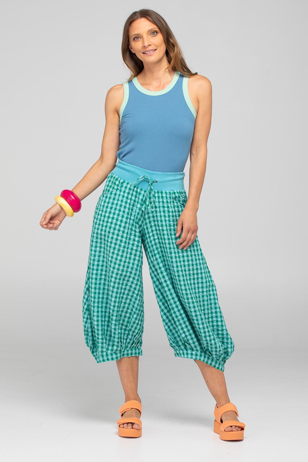 A model wearing the Guru Cotton Pant in colour Green (Green), from the front, showing the whole outfit