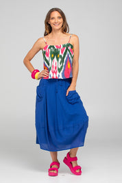 A model wearing the Guru Cotton Skirt in colour Blu (Blue), from the front, showing the whole outfit