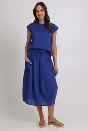Model Madeline wearing size 10 of the Guru Cotton Skirt in colour Blu (Blue), from the front, showing the whole outfit