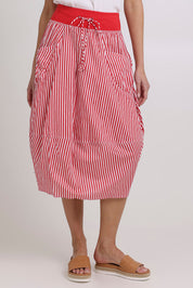 Model Madeline wearing size 10 of the Guru Cotton Skirt in colour Emilias (Red), from the front, cropped image