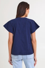 Model Madeline wearing size 10 of the Livy Cotton Top in colour Navy (Blue), from the back