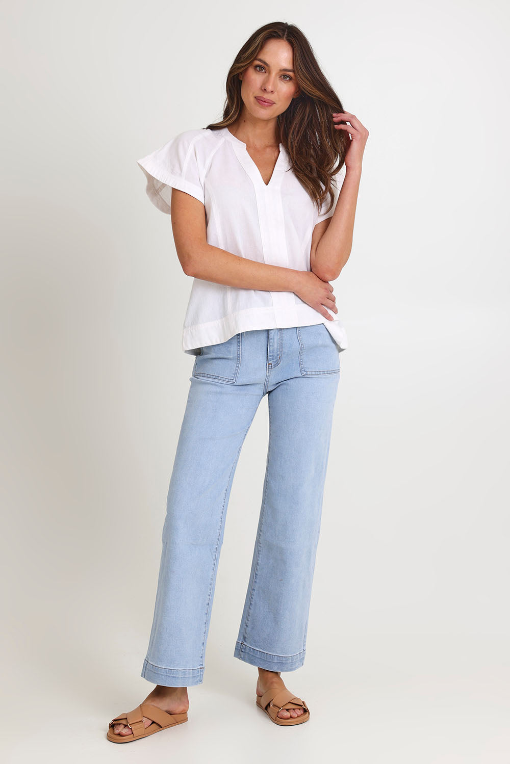 Model Madeline wearing size 10 of the Livy Cotton Top in colour White (White), from the front, showing the whole outfit