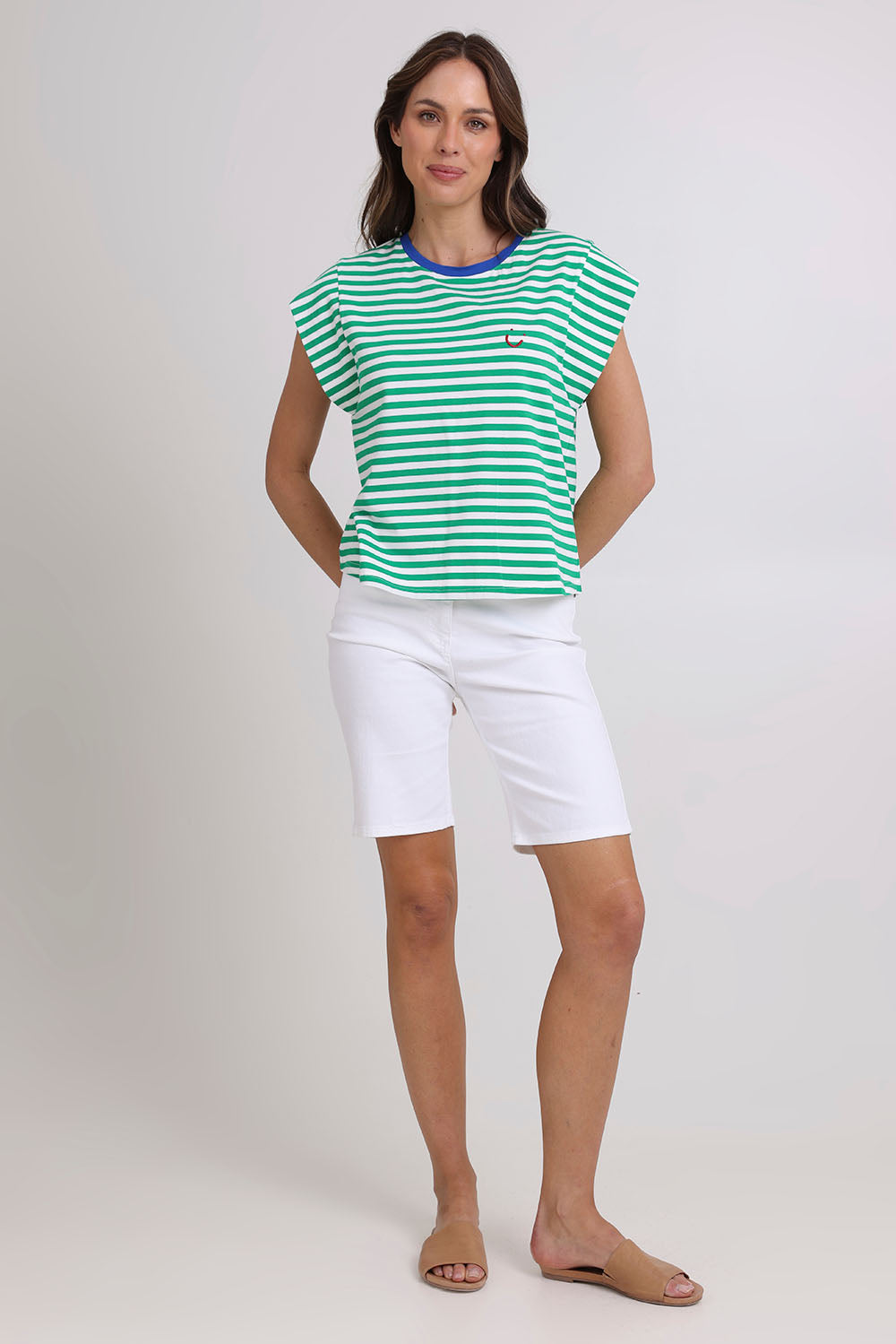 Model Madeline wearing size S of the Bellissimo Cotton Tee in colour Green (Green), from the front, showing the whole outfit