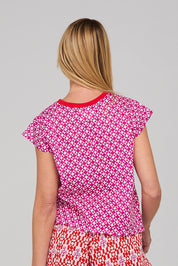 A model wearing the Leaf Cotton Top in colour Naples (Pink), from the back