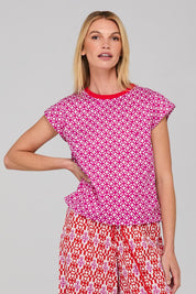 A model wearing the Leaf Cotton Top in colour Naples (Pink), from the front, cropped image