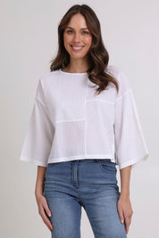 Model Madeline wearing size 10 of the Dimple Cotton Top in colour White (White), from the front, cropped image
