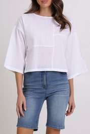 Model Madeline wearing size 10 of the Dimple Cotton Top in colour White (White), from the front, cropped image