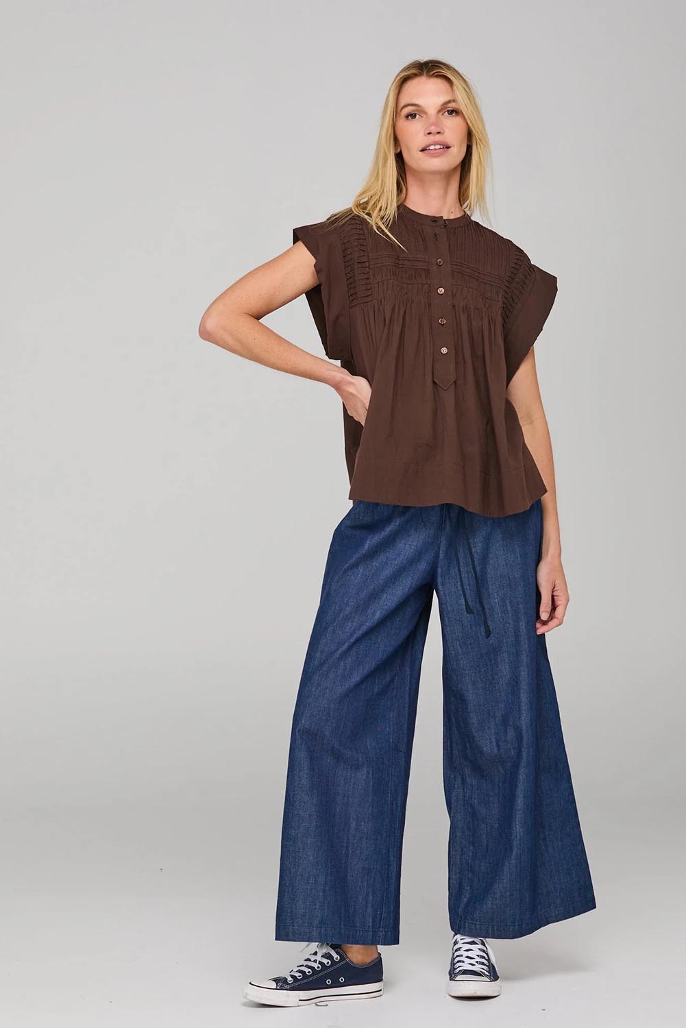 A model wearing the Danika Cotton Top in colour Coffee, from the front, showing the whole outfit