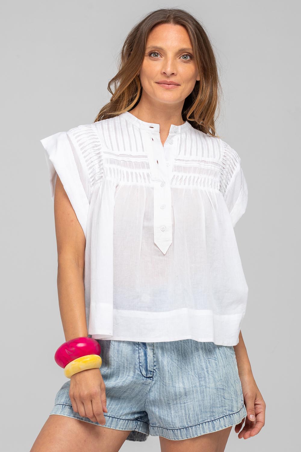 A model wearing the Danika Cotton Top in colour White (White), from the front, cropped image