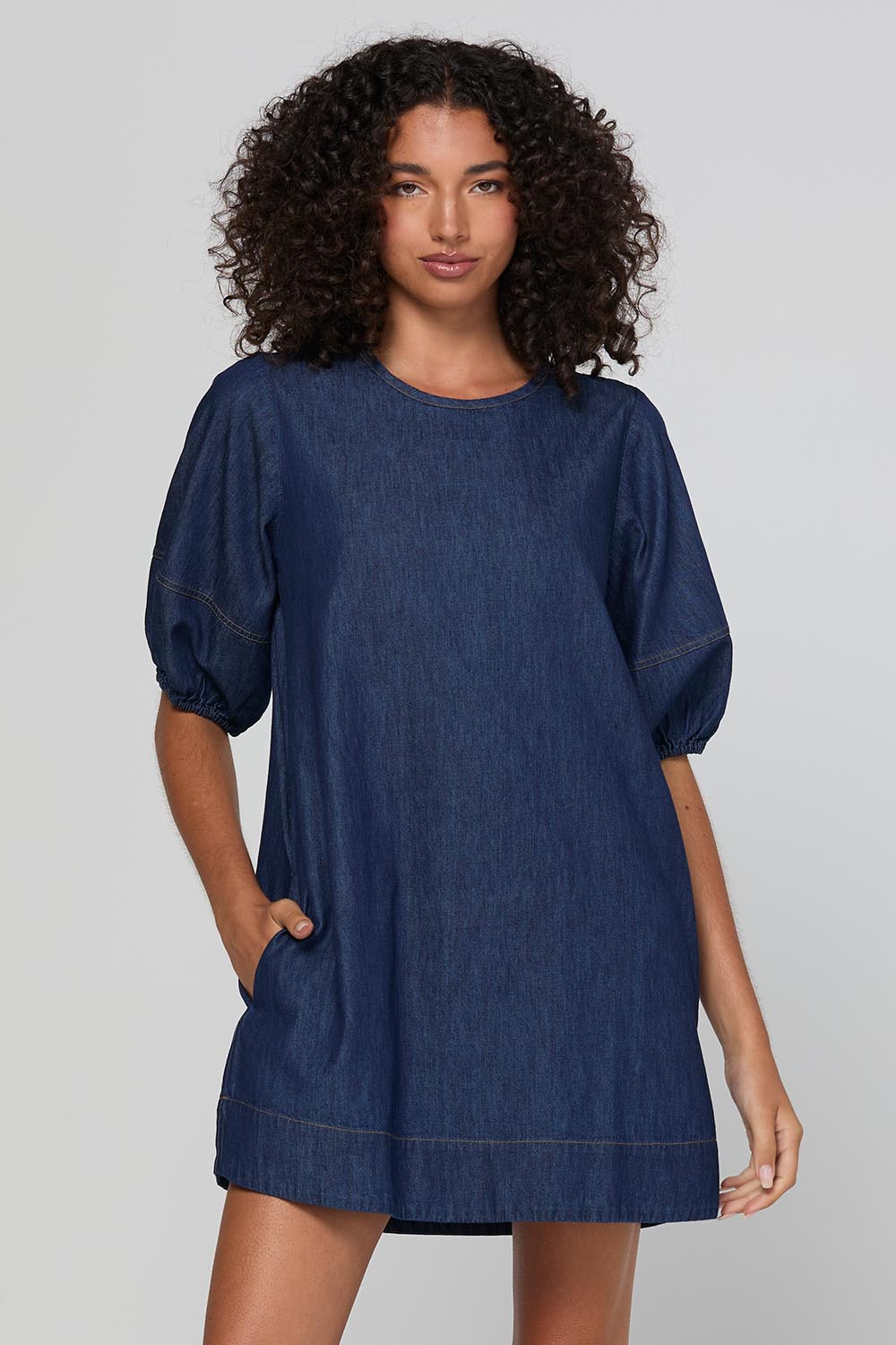 Model Genericm wearing size sample of the Ava Dress – Darkdenim in colour Darkdenim, in a cropped view
