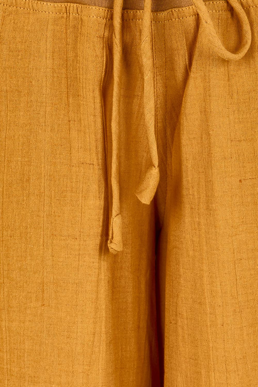 Product shot of the Guru Pant – Turmeric in colour Turmeric, showing detail