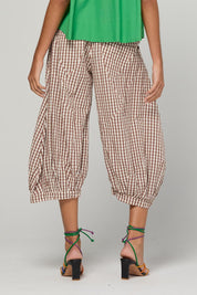 Model Genericm wearing size sample of the Guru Pant – Cocoa in colour Cocoa, from an angle