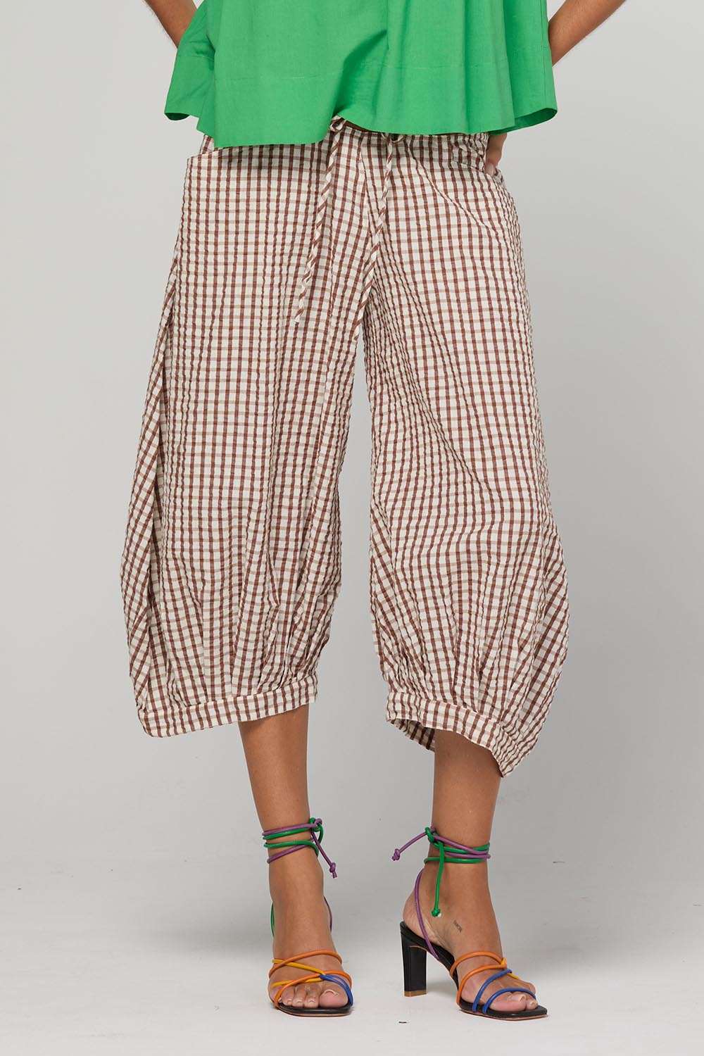 Model Genericm wearing size sample of the Guru Pant – Cocoa in colour Cocoa, in a cropped view