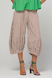Model Genericm wearing size sample of the Guru Pant – Cocoa in colour Cocoa, in a cropped view