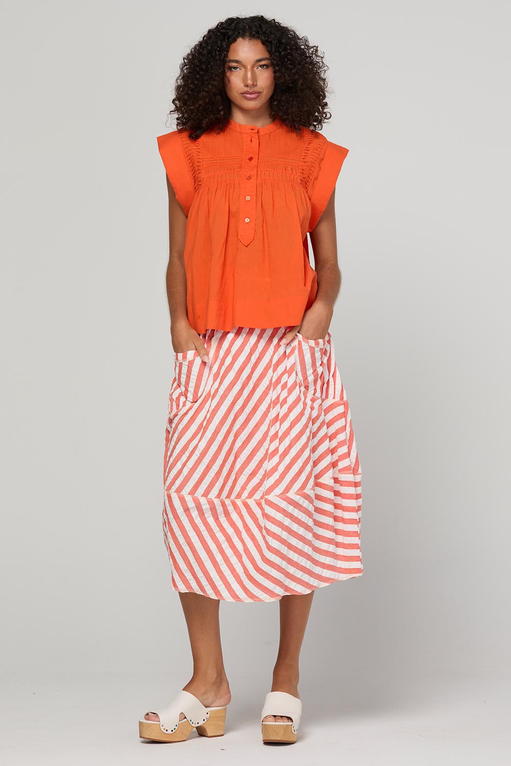 Model Genericm wearing size sample of the Guru Skirt – Watermelon in colour Watermelon, from the front