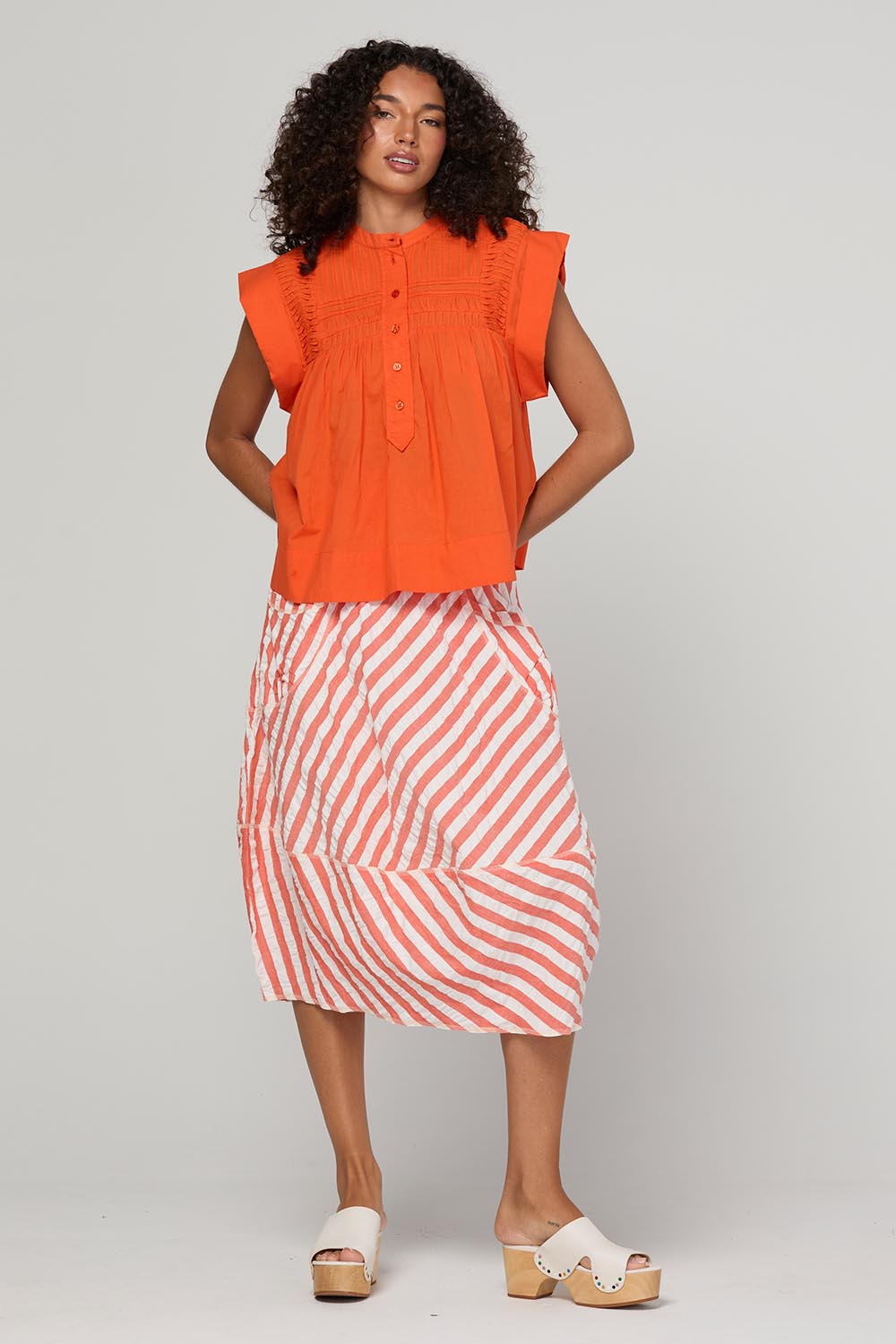 Model Genericm wearing size sample of the Guru Skirt – Watermelon in colour Watermelon, from the front